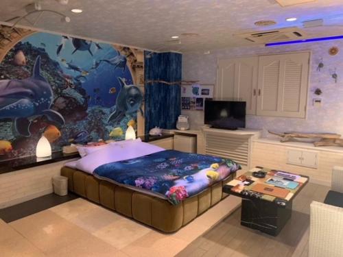 a bedroom with a large fish painting on the wall at Hotel HANAMIZUKI-Adult Only in Otaru