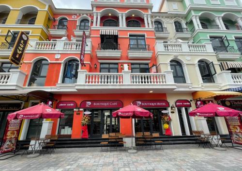 un edificio con sombrillas rojas delante de él en Venice River View P Boutique Hotel - Grand World Phú Quốc, en Phu Quoc