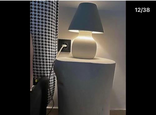 a lamp sitting on top of a table at no.21house studio apartment in Rio