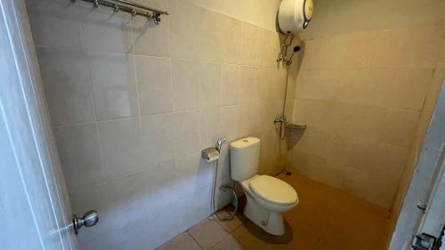 a bathroom with a white toilet in a room at Planters Guest House in Yogyakarta