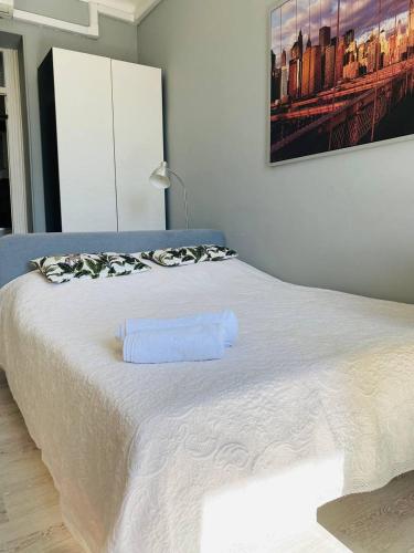 a white bed with a towel on top of it at RIVIERA STUDIO CANNES CENTER in Cannes