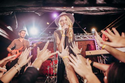 a crowd of people raising their hands at a concert at Utopia Beach Club in Okurcalar