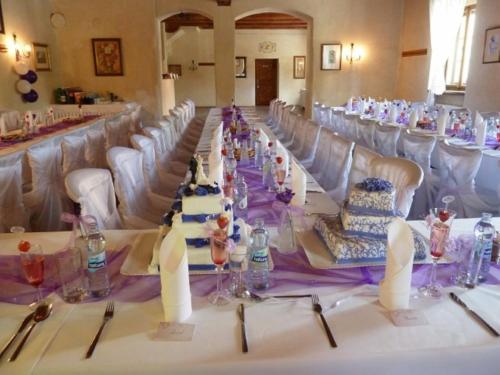 a long table in a room with white chairs at Penzion U Kriveho psa in Frýdek-Místek