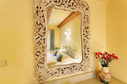 an ornate mirror on a wall in a room at Penzion U Kriveho psa in Frýdek-Místek
