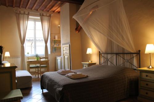 a bedroom with a large bed and a window at Residenza Sant' Andrea in Lucca