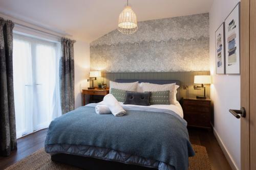 a bedroom with a large bed with a blue blanket at The Workshop in York