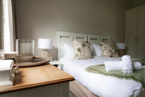 a bedroom with a bed and a table with a plate on it at Porterfield Guest House, Champagne Valley in Champagne Valley