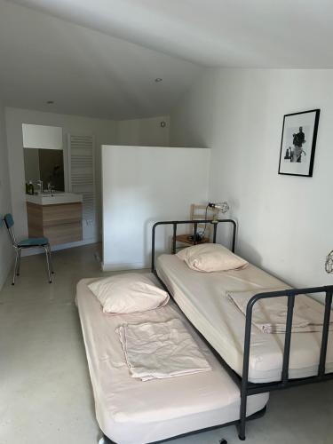 two bunk beds in a room with a chair at My Home in lourmarin in Lourmarin