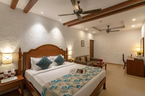 a bedroom with a bed and a living room at Adamo The Bellus Calangute in Calangute
