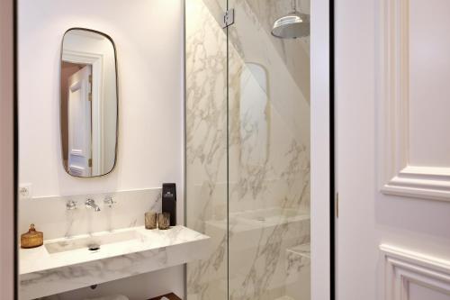 a bathroom with a sink and a shower at De Lindenhoeve Boutique Hotel in Sluis