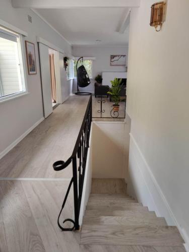 a hallway of a home with a bench and a staircase at Lake View House entire house in Gosford