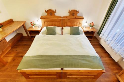 a bedroom with a large bed with a wooden headboard at Penzion U Kriveho psa in Frýdek-Místek