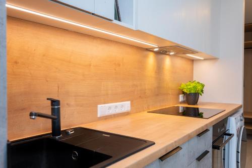 a kitchen with a sink and a counter top at Aatrium Kinnisvara Riia str 20A apartment, 7-th floor in Tartu