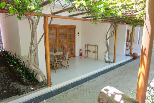 a patio with a table and a tree at Bluewater Maribago Beach Resort in Mactan