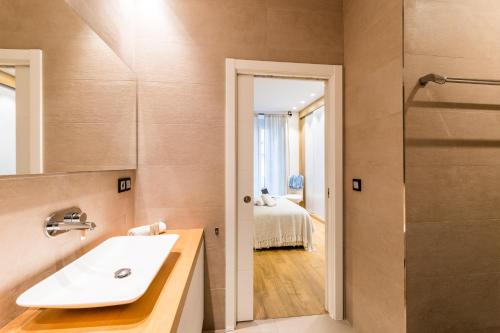 a bathroom with a sink and a shower at BOULEVARD SUITE APARTMENT in San Sebastián