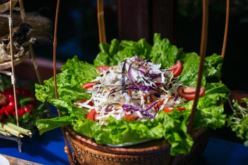 a salad in a basket with lettuce at La Regina Classic Cruise in Ha Long
