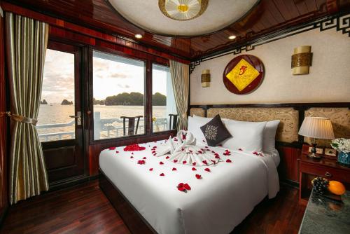 a bedroom with a bed with red flowers on it at La Regina Classic Cruise in Ha Long