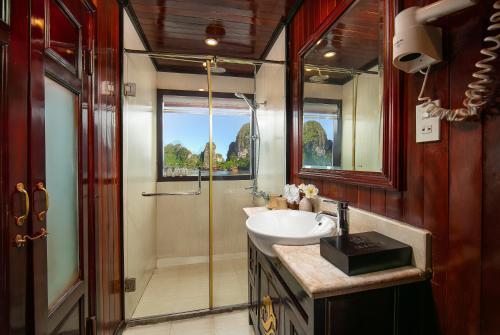 a bathroom with a sink and a shower at La Regina Classic Cruise in Ha Long
