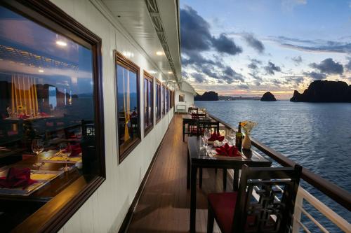 a restaurant on a boat with a view of the water at La Regina Classic Cruise in Ha Long
