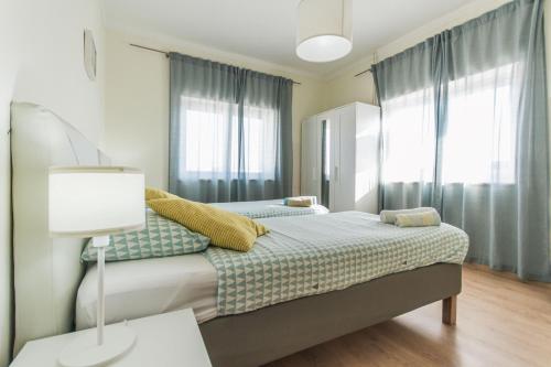 a bedroom with two beds and a table with a lamp at Beach Avenue Apartment in Ferrel