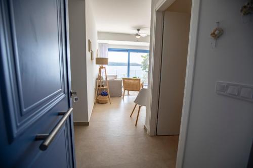 a hallway with a door and a room with a view at Greek Beach House A3 Lefkada in Nydri