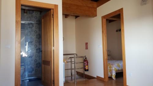 a room with a door leading to a bedroom with a bed at La Casuca de Rosi en Suances in Suances