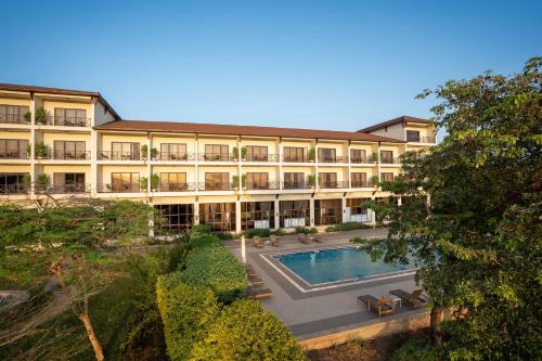 a large building with a swimming pool in front of it at Haile Resort Arbaminch in Migie