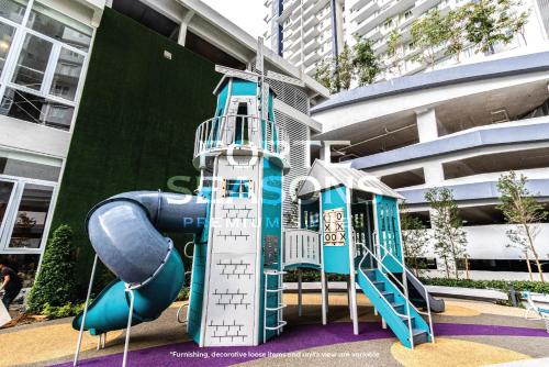 a playground with a slide in front of a building at Forte Seasons Genting Windmill Upon Hills in Genting Highlands