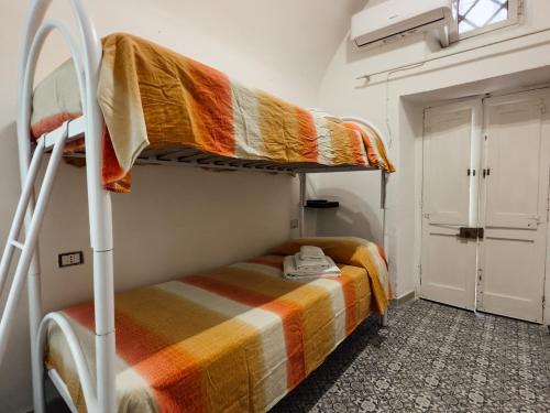 a room with two bunk beds and a window at Dimora Garibaldi Rooms - center-Wi-fi in Gallipoli