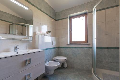 a bathroom with a toilet and a sink and a shower at Villa Bali in Kaštelir