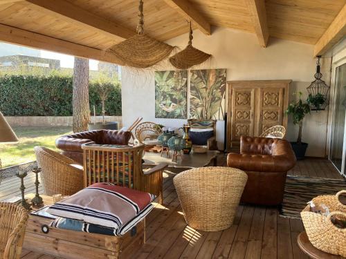 a living room with chairs and a table at Maison "LA ROSALINDA-2B" Ghisonaccia in Ghisonaccia