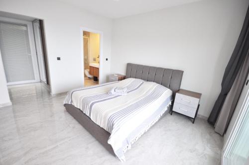 a bedroom with a bed and a night stand at Villa Esteban Özel Plajlı in Bogazici