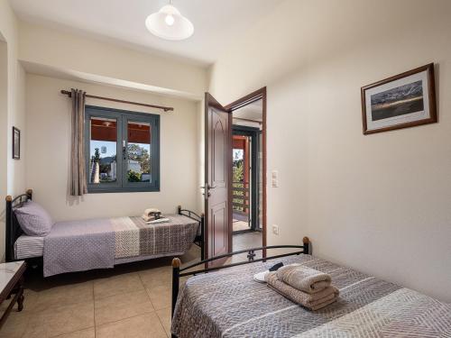 a bedroom with two beds and a balcony at Villa Anastasia in Sívas