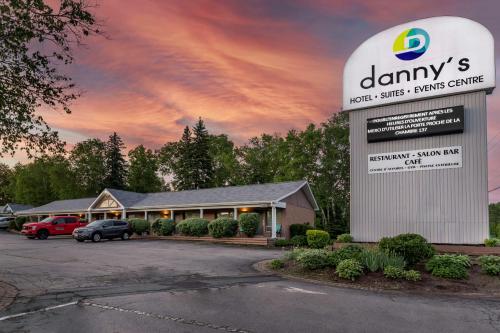 a building with a sign in front of a parking lot at Dannys Hotel Suites; SureStay Collection by Best Western in Beresford