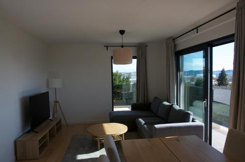 a living room with a couch and a table at Nikola Luxury Apartments Borik in Zadar