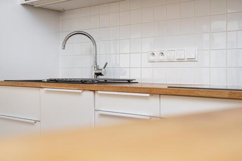 a kitchen with a sink and a counter at Silver House by Q4Apartments in Gdynia