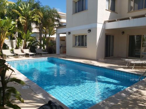 a swimming pool in front of a villa at Anthorina 21 in Protaras