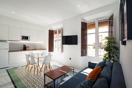 a living room with a couch and a table at Granadi Apartamentos in Granada