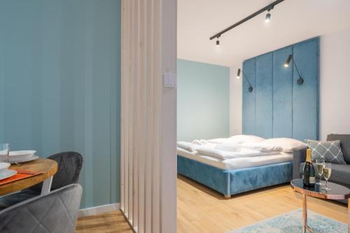 a bedroom with a bed and a living room at Bałtycka Głębia in Gąski