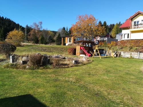 a yard with a house and a playground at Apartments Pernink 341 in Pernink