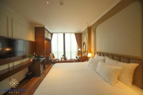Postel nebo postele na pokoji v ubytování L'amant de Hanoi Hotel - khách sạn Lamant de Hà Nội