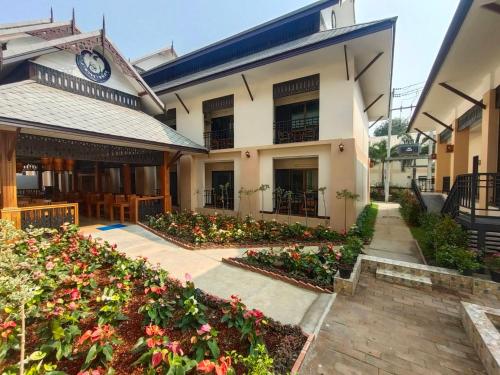 a building with a clock on the side of it at Peacock De Pai Hotel in Pai