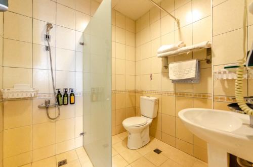 a bathroom with a shower and a toilet and a sink at Sweet B&B 幸福微甜民宿 in Ji'an