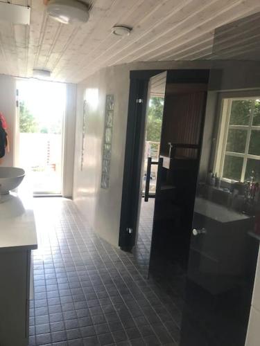 a kitchen with a sink and a mirror in a room at Villa Verstas Karjalohja in Karjalohja