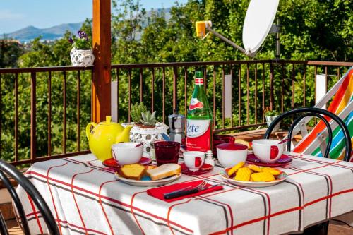 a table with plates of food and a bottle of coke at Livingapple in Scauri