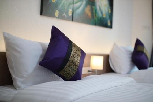 two pillows on a bed in a hotel room at Peacock De Pai Hotel in Pai