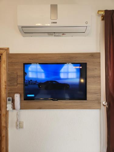a flat screen tv on a wall in a room at Kadıköy White House in Istanbul