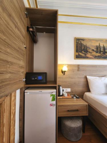 a small room with a refrigerator and a bed at Kadıköy White House in Istanbul