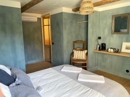 une chambre avec un lit et une chaise dans l'établissement Beauregard Cévennes - Magnifique chambre d'hôtes, indépendante et moderne, à Monoblet