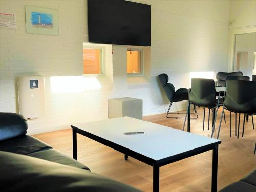 a living room with a table and chairs at Hirtshals Idrætscenter - Vandrehjem - Hostel in Hirtshals
